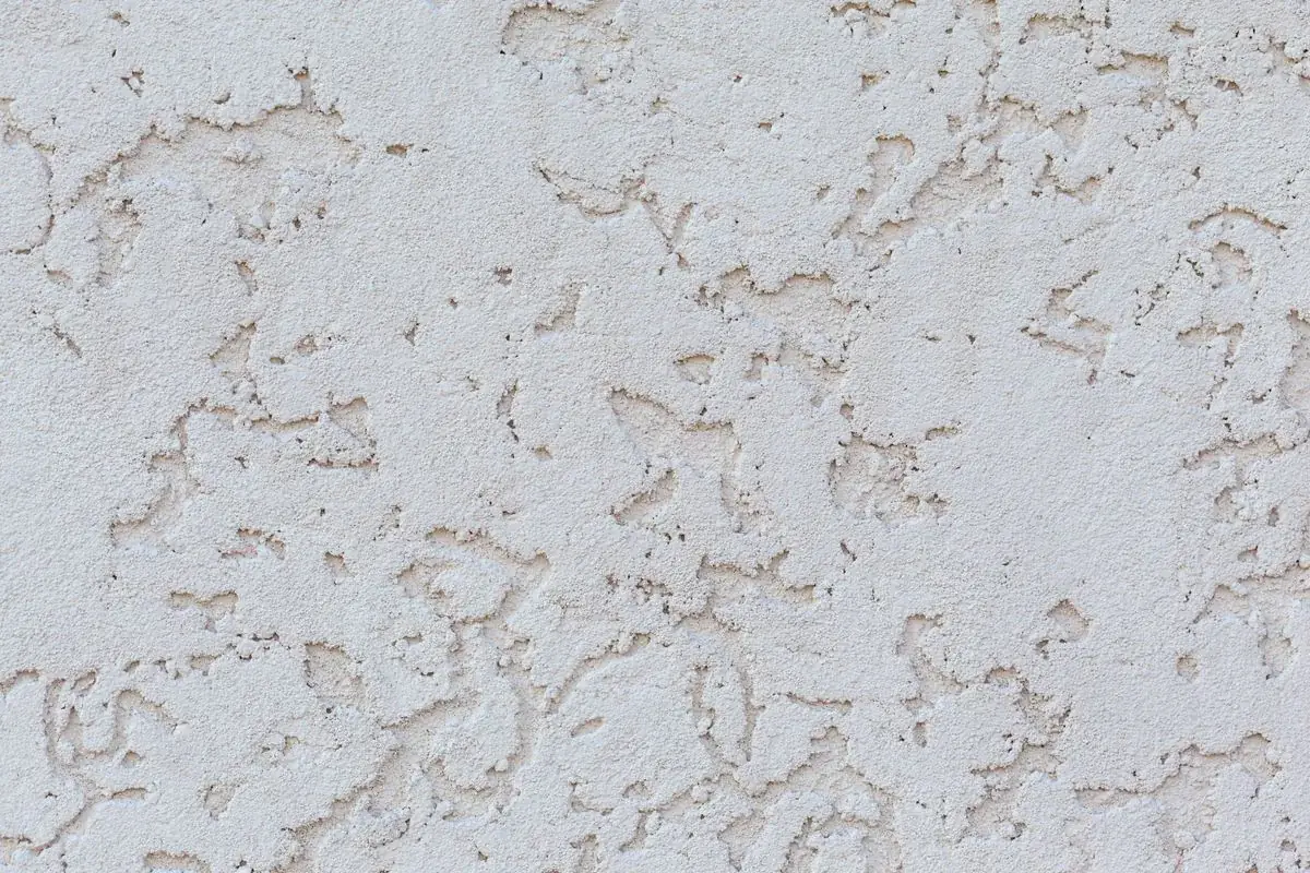 White synthetic stucco finish texture on exterior wall